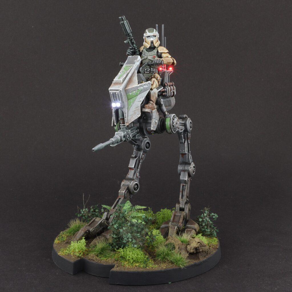 A Star Wars Legion miniature - 34mm scale. Fully painted with some LED modifications on. It shows an AT-RT and a Clone Scout rider on top of it.